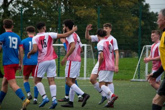 Players from UA92 Men's First Team Football celebrate a goal.